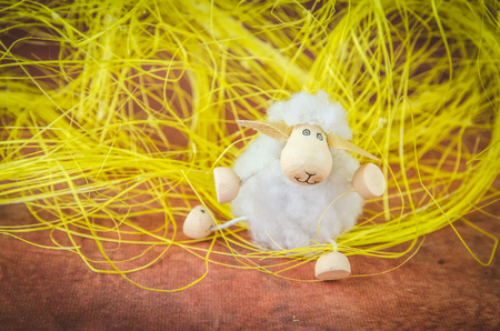 Easter sheep decoration against brown backgroundの写真素材