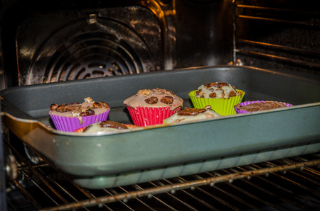 muffin in colorful shapes in the ovenの写真素材