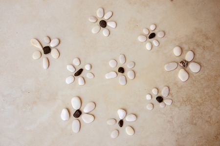 structured patters made from stony pebble in shape of flowersの写真素材