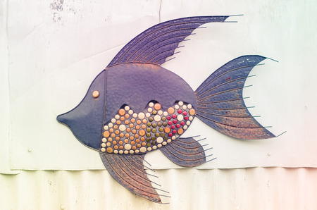 beautiful metal decoration of fish hang on the wallの写真素材