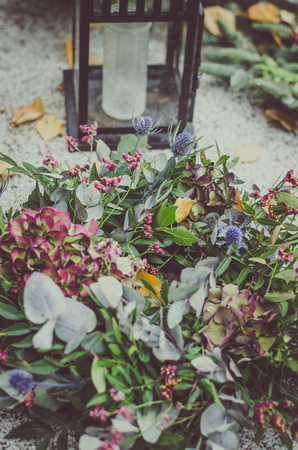 decoration from dry colorful flowers in the cemetery at All Saints Day in autumn timeの写真素材