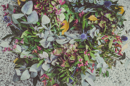 decoration from dry colorful flowers in the cemetery at All Saints Day in autumn timeの写真素材