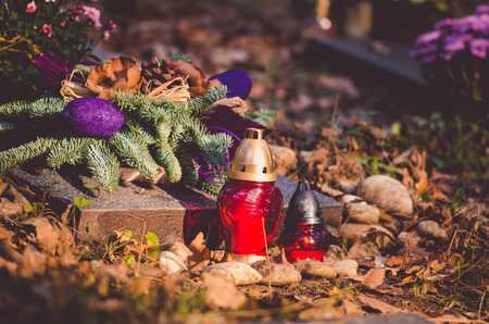 Colorful flower and candle decoration during All Saints Day at the cemeteryの写真素材