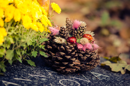 Graves with All Saint Day decoration and leaves in autumn atmosphereの写真素材