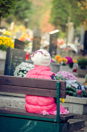 child praying in cemetery during  All Saints Dayの写真素材