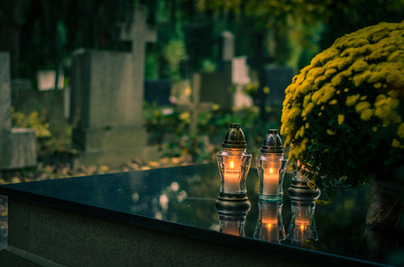 Colorful burning candles during All Saints Day at the cemeteryの写真素材