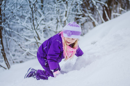 little girls   in winter time having fun in snow