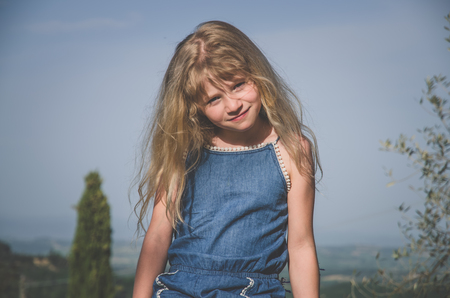 adorable little child with long blond hairの写真素材