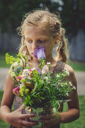 lovely girl holding bouquet of  beautiful colorful flowersの写真素材