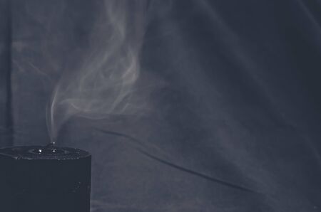 smoke over blown out candleの写真素材
