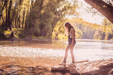 still child standing in misty and dusky atmosphere in summer sunny day