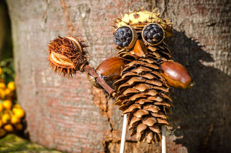 cute figure from chestnut, leaves and flowers in vibrant autumnal colorsの写真素材