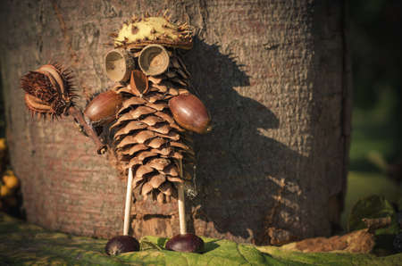 cute figure from chestnut, leaves and flowers in vibrant autumnal colorsの写真素材
