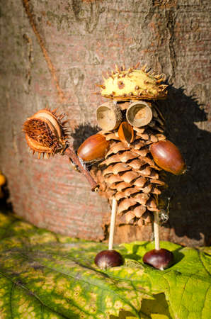 cute figure from chestnut, leaves and flowers in vibrant autumnal colorsの写真素材