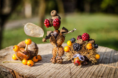 cute figure from chestnut, leaves and flowers in vibrant autumnal colorsの写真素材