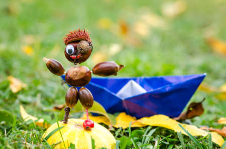 cute figure from chestnut, leaves and flowers in vibrant autumnal colorsの写真素材