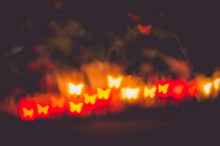 illuminated glittering bokeh with butterfly shape copy space backgroundの写真素材