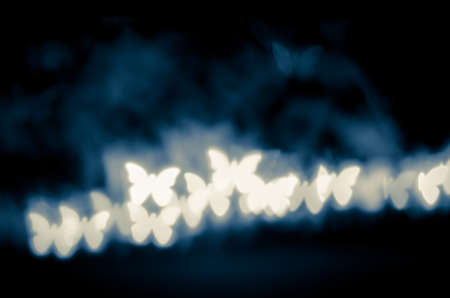 illuminated glittering bokeh with butterfly shape copy space backgroundの写真素材