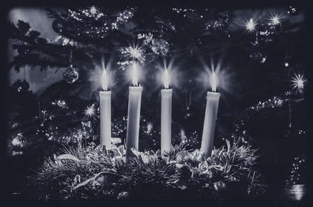 burning candles, scissors and green twigs components on wooden tableの写真素材