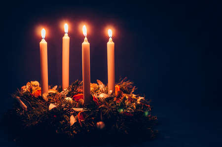 burning candles, scissors and green twigs components on wooden tableの写真素材