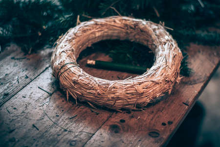 burning candles, scissors and green twigs components on wooden tableの写真素材