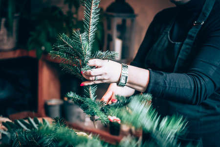 burning candles, scissors and green twigs components on wooden tableの写真素材