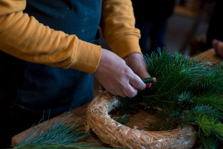 burning candles, scissors and green twigs components on wooden tableの写真素材