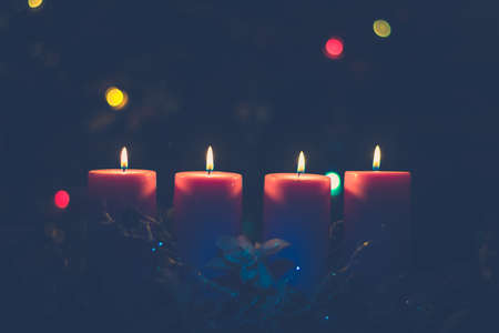 four burning candles with traditional festive cristian atmosphere full of light and magicの写真素材