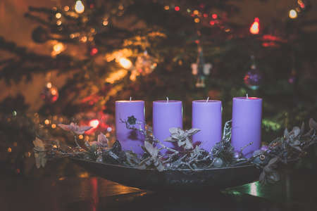 four burning candles with traditional festive cristian atmosphere full of light and magicの写真素材
