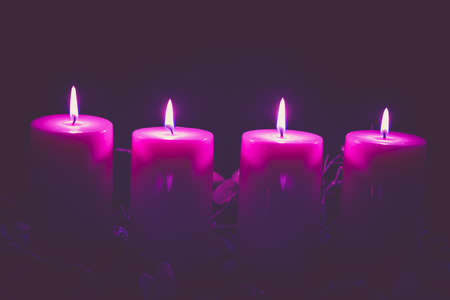 four burning candles with traditional festive cristian atmosphere full of light and magicの写真素材
