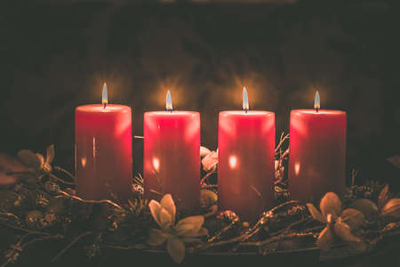 four burning candles with traditional festive cristian atmosphere full of light and magicの写真素材