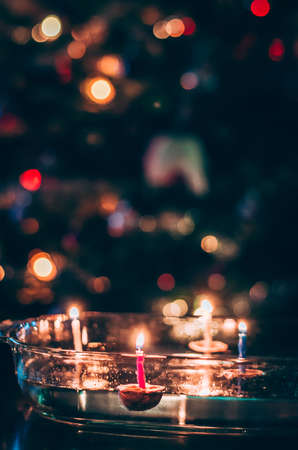 christmas tradition of nut shells floating on water surface, eastern Europe tradition with bokeh backgroundの写真素材
