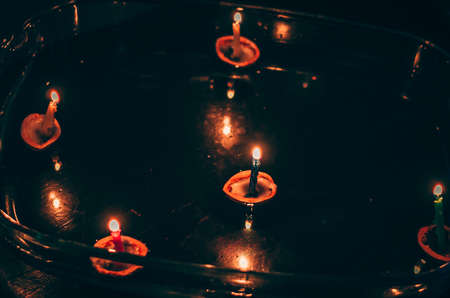 christmas tradition of nut shells floating on water surface, eastern Europe tradition with bokeh backgroundの写真素材