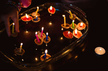 christmas tradition of nut shells floating on water surface, eastern Europe tradition with bokeh backgroundの写真素材