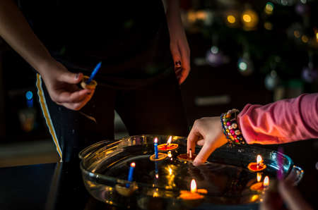 christmas tradition of nut shells floating on water surface, eastern Europe tradition with bokeh backgroundの写真素材