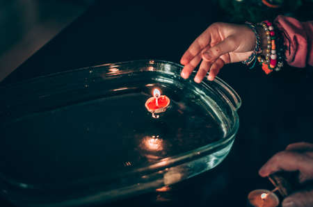 christmas tradition of nut shells floating on water surface, eastern Europe tradition with bokeh backgroundの写真素材