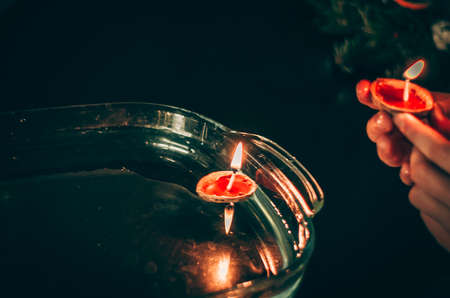 christmas tradition of nut shells floating on water surface, eastern Europe tradition with bokeh backgroundの写真素材