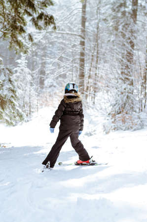 adorable girl in winter forest enjoying snowy atmosphereの写真素材