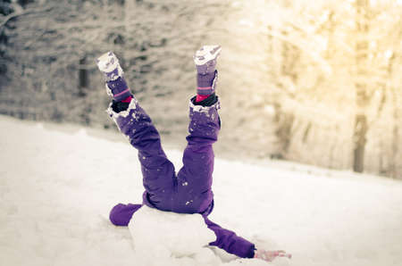 two beautiful girl having fun with snowman in winter forestの写真素材