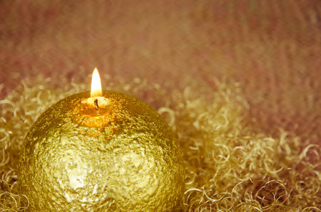 shining red christmas box with surprise inside in golden backgroundの写真素材