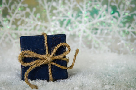 shining red christmas box with surprise inside in golden backgroundの写真素材