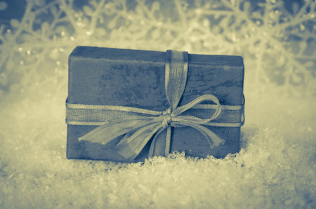 shining red christmas box with surprise inside in golden backgroundの写真素材