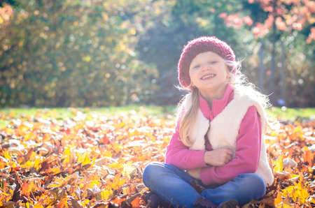 portrait of smiling girl in colorful autumnal atmosphereの写真素材