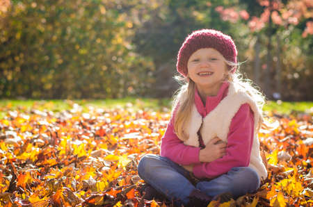 portrait of smiling girl in colorful autumnal atmosphere