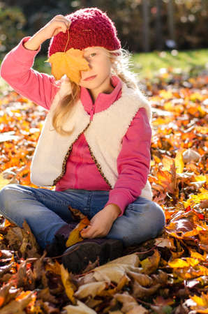 portrait of smiling girl in colorful autumnal atmosphereの写真素材