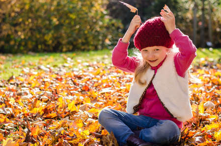 portrait of smiling girl in colorful autumnal atmosphereの写真素材