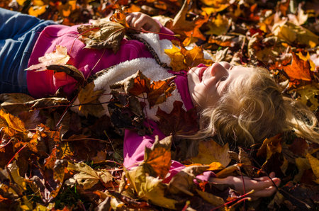 portrait of smiling girl in colorful autumnal atmosphereの写真素材