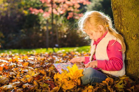 portrait of smiling girl in colorful autumnal atmosphereの写真素材