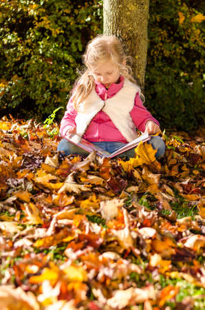 portrait of smiling girl in colorful autumnal atmosphereの写真素材