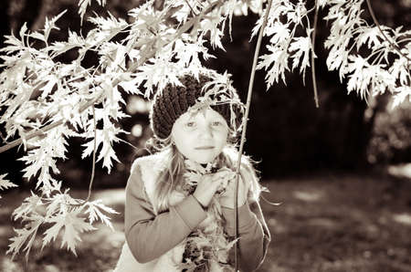 portrait of smiling girl in colorful autumnal atmosphereの写真素材